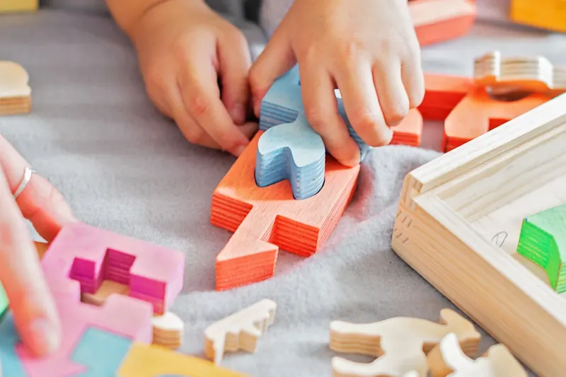 Mains d'enfants assemblant les pieces d'un jeu